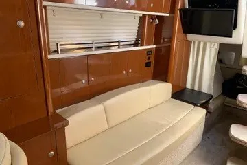 Slide: The Image of Interior of 2008 Sea Ray Sundancer 310 with beige sofa and wooden cabinetry. - 8