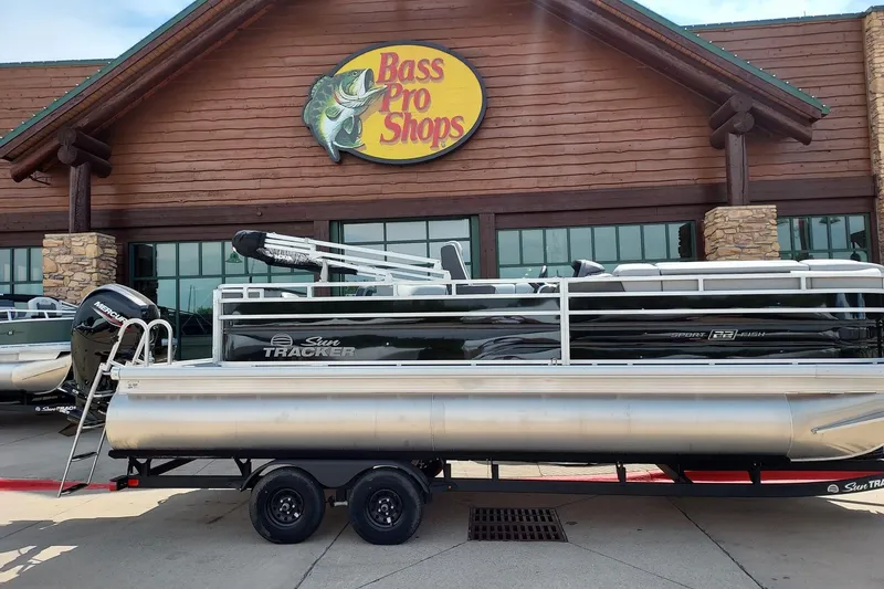 The Image of 2027 Sun Tracker SportFish 22 DLX pontoon boat at Bass Pro Shops entrance. - 0