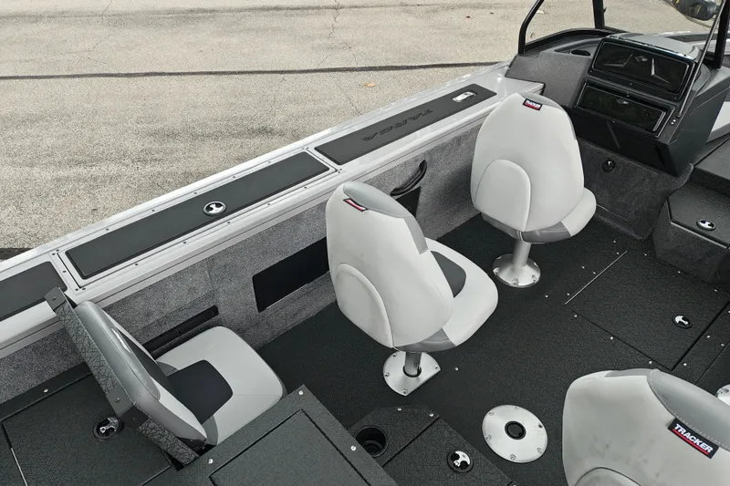 Slide: The Image of Interior of 2027 Tracker Targa V-18 Combo boat with gray seating and modern dashboard. - 26