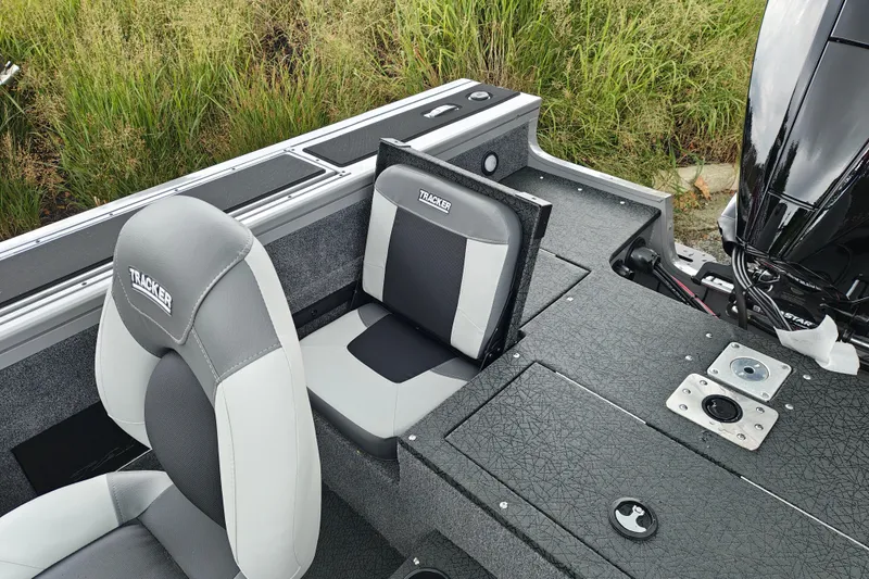 Slide: The Image of 2027 Tracker Targa V-18 Combo boat interior with gray seating and motor detail. - 20