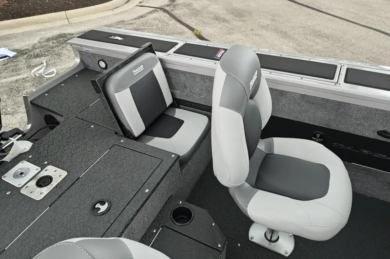 Slide: The Image of 2027 Tracker Targa V-18 Combo boat interior with gray seating and storage compartments. - 19