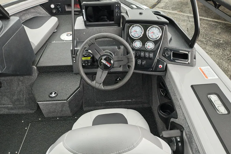 Slide: The Image of Interior of 2027 Tracker Targa V-18 Combo boat with steering wheel and dashboard controls. - 28
