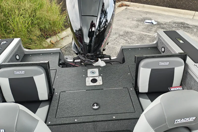 Slide: The Image of 2027 Tracker Targa V-18 Combo boat interior with seating and motor view. - 18