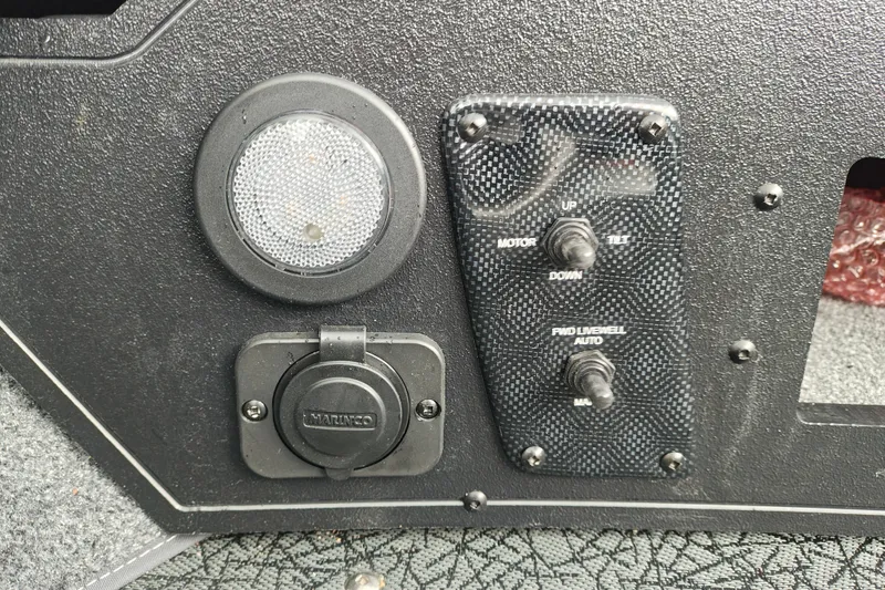 Slide: The Image of Control panel of 2027 Tracker Targa V-18 Combo boat with switches and light. - 38
