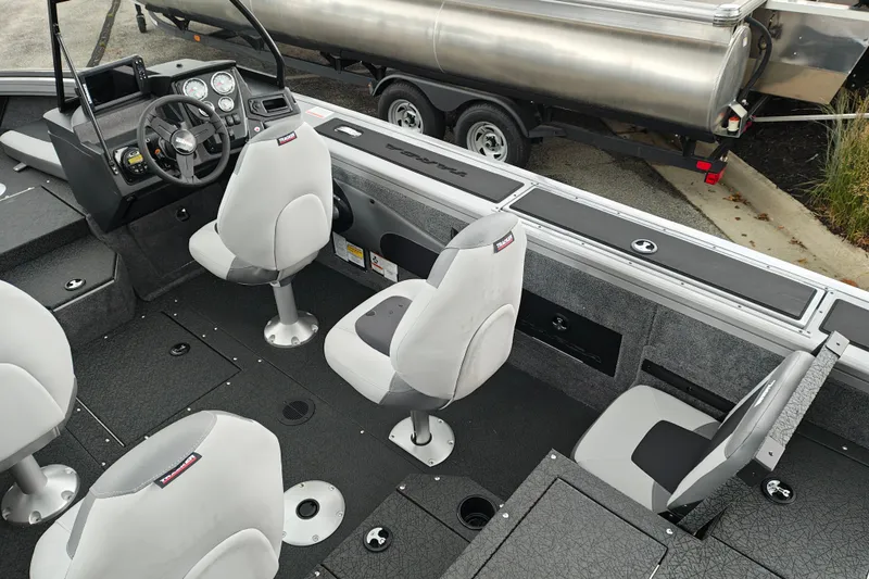 Slide: The Image of 2027 Tracker Targa V-18 Combo boat interior with seating and control panel. - 24