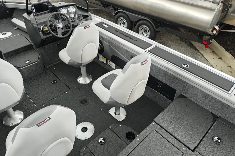 Slide: The Image of Interior of 2027 Tracker Targa V-18 Combo boat with seating and control panel. - 25