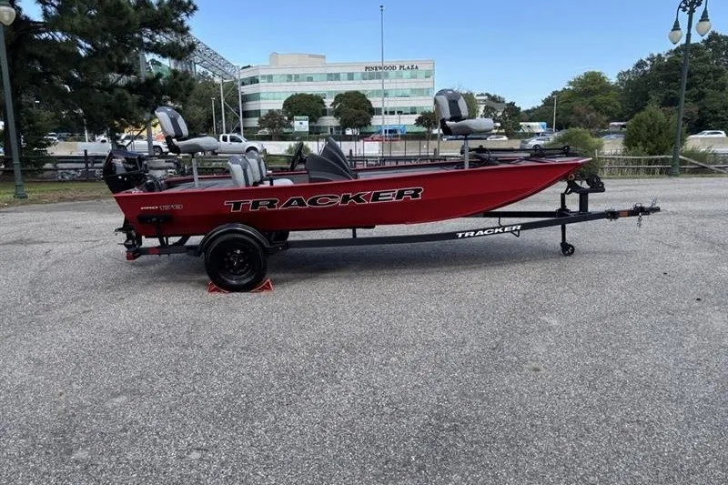 Slide: The Image of 2027 Tracker Pro 170 boat on trailer, parked outdoors near Pinewood Plaza. - 35