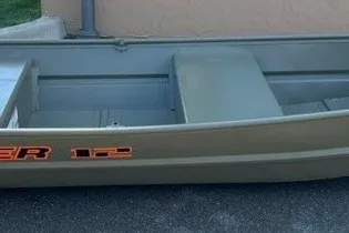 The Image of 2027 Tracker Grizzly 12 Jon boat, side view, parked on pavement. - 0