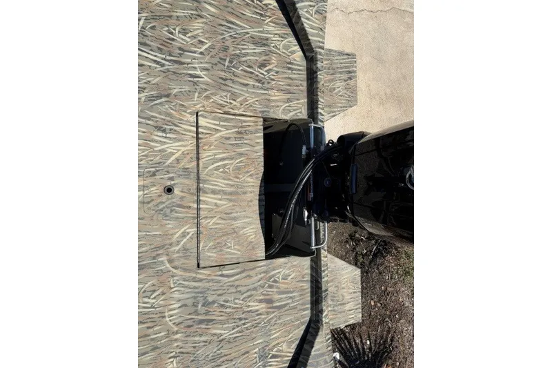 Slide: The Image of Top view of 2027 Tracker Grizzly 1860 CC boat with camouflage pattern and motor. - 13