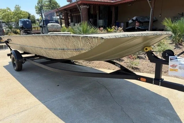 The Image of 2027 Tracker Grizzly 1860 CC boat on trailer, parked outdoors. - 0