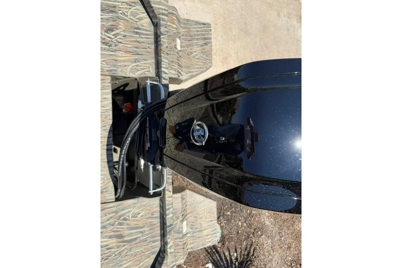 Slide: The Image of 2027 Tracker Grizzly 1860 CC boat engine, top view, with camouflage deck. - 15