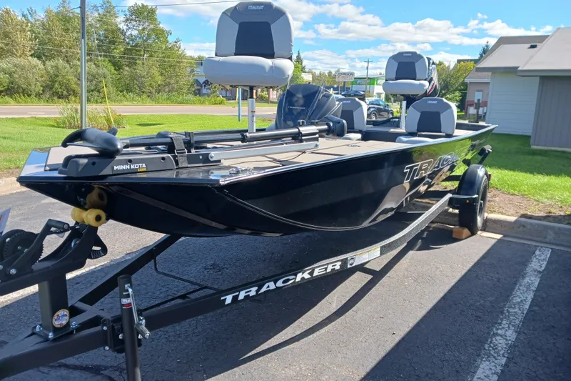 The Image of 2027 Tracker Pro 170 boat on trailer, featuring Minn Kota motor, parked outdoors. - 0
