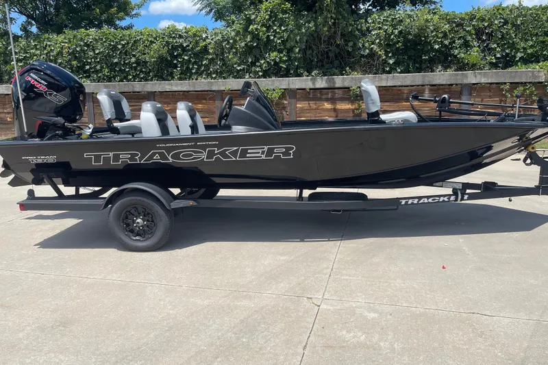 The Image of 2027 Tracker Pro Team 190 boat on trailer, sleek black design, outdoor setting. - 0