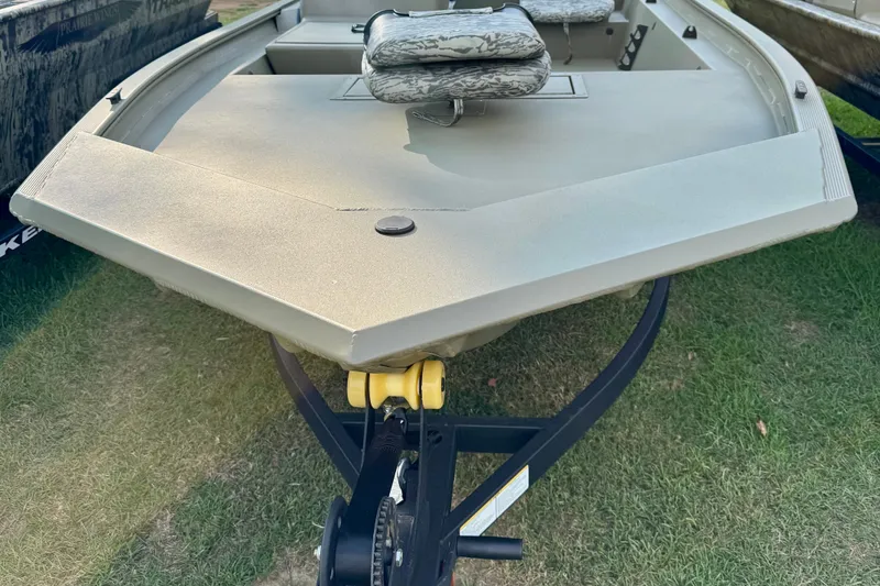 The Image of 2027 Tracker Grizzly 1754 SC boat on trailer, featuring camouflage seating. - 0