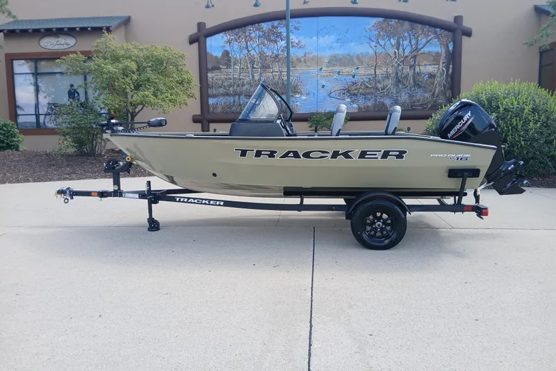The Image of 2027 Tracker Pro Guide V-16 WT boat on trailer, outdoor setting. - 0