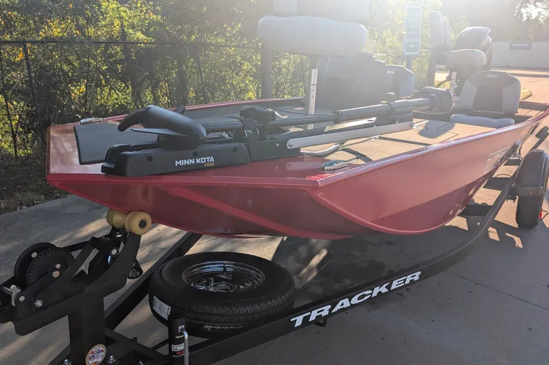 The Image of 2027 Tracker Pro 170 boat with Minn Kota motor on trailer in sunlight. - 0