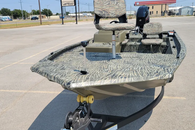 The Image of 2027 Tracker Grizzly 1754 SC boat with camouflage design in a parking lot. - 0