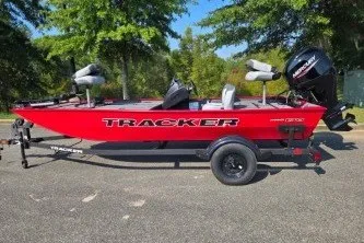 The Image of 2027 Tracker Pro 170 boat in vibrant red on a trailer, parked outdoors. - 0