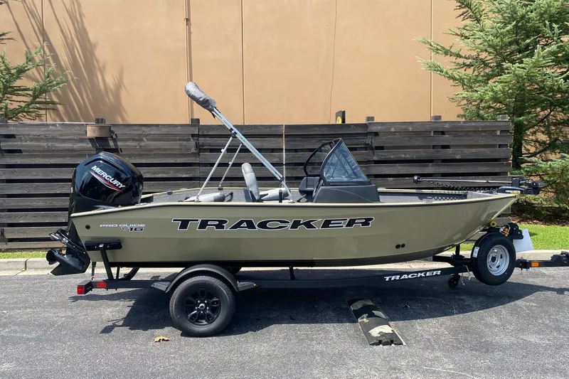 The Image of 2027 Tracker Pro Guide V-16 WT boat on trailer, parked outdoors. - 0