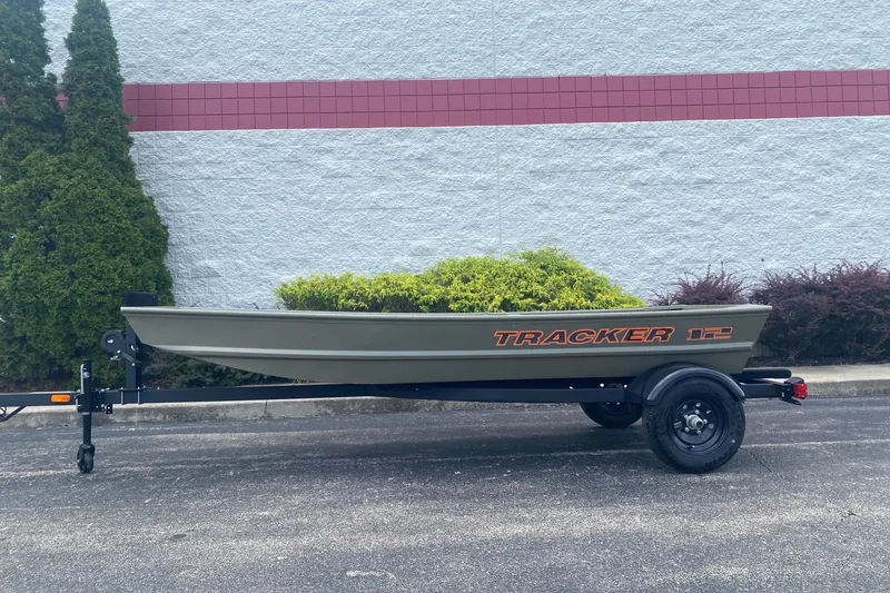 The Image of 2027 Tracker Grizzly 12 Jon boat on trailer, parked outdoors. - 0