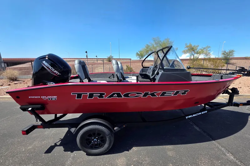 The Image of 2027 Tracker Pro Guide V-16 WT boat, red exterior, on trailer, with Mercury engine. - 0