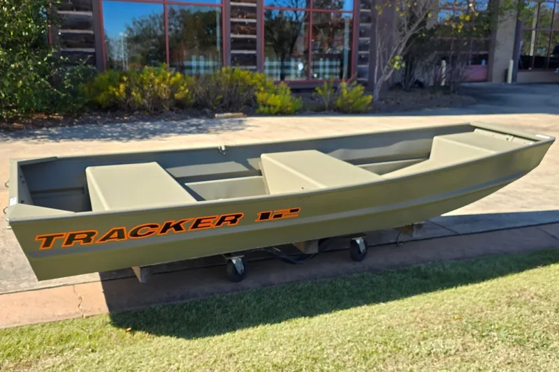 The Image of 2027 Tracker Grizzly 12 Jon boat on display outdoors, showcasing its sturdy design. - 0