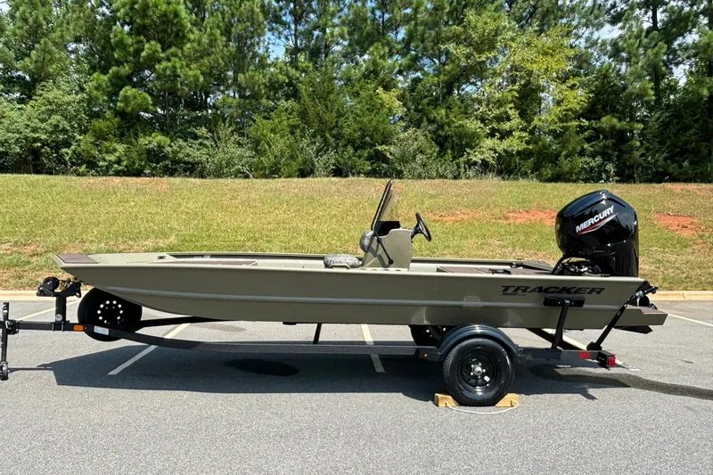 The Image of 2027 Tracker Grizzly 1860 CC boat on trailer, parked outdoors. - 0