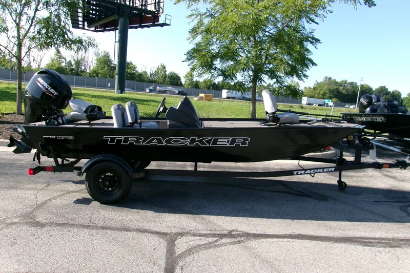 The Image of 2027 Tracker Pro 170 boat on trailer, parked outdoors near trees. - 0