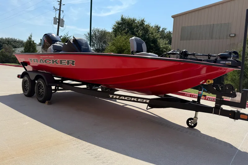 The Image of Red 2027 Tracker Pro Team 195 boat on trailer, parked outdoors. - 0