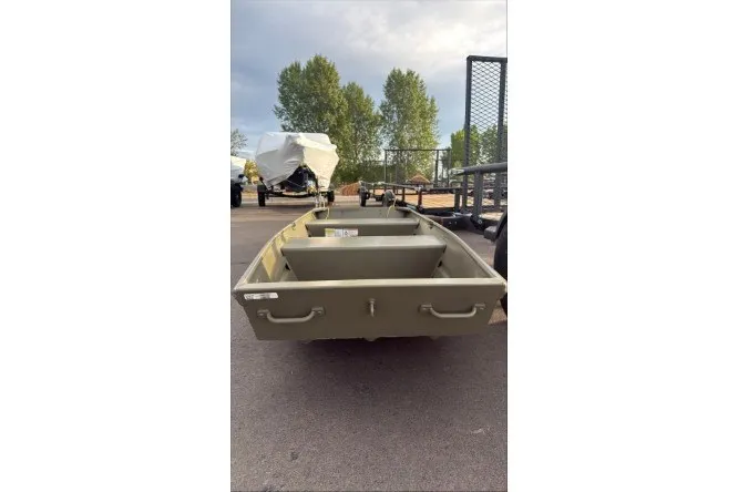 The Image of 2027 Tracker Grizzly 12 Jon boat on pavement, surrounded by trees and trailers. - 0