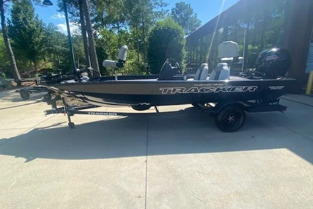 The Image of 2027 Tracker Pro Team 190 boat on trailer, parked outdoors in sunny setting. - 0