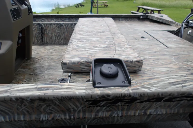 Slide: The Image of 2027 Tracker Grizzly 1860 CC boat interior with camouflage design and seating. - 14