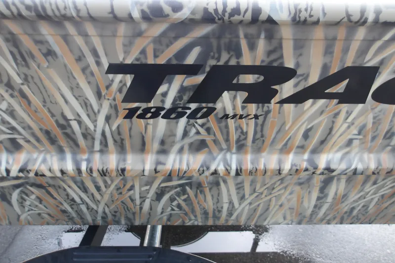 Slide: The Image of 2027 Tracker Grizzly 1860 CC boat with camouflage design and bold lettering. - 13