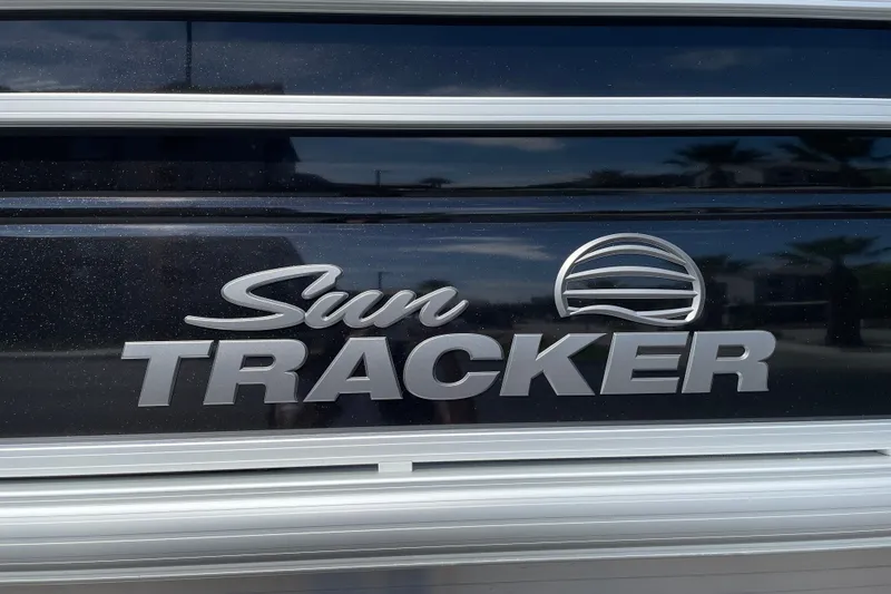 Slide: The Image of Sun Tracker SportFish 22 DLX 2027 logo on sleek black surface. - 26