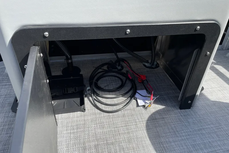 Slide: The Image of Storage compartment of 2027 Sun Tracker SportFish 22 DLX with cables and equipment. - 15
