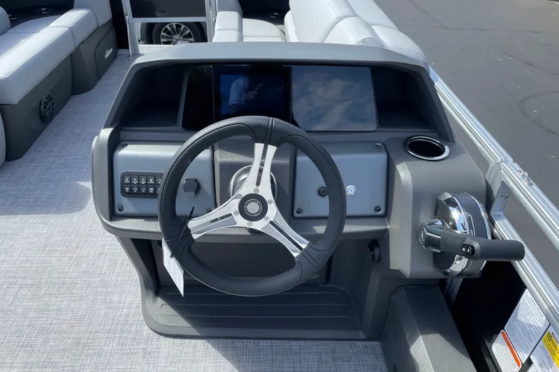 Slide: The Image of 2027 Sun Tracker SportFish 22 DLX boat dashboard with steering wheel and controls. - 18