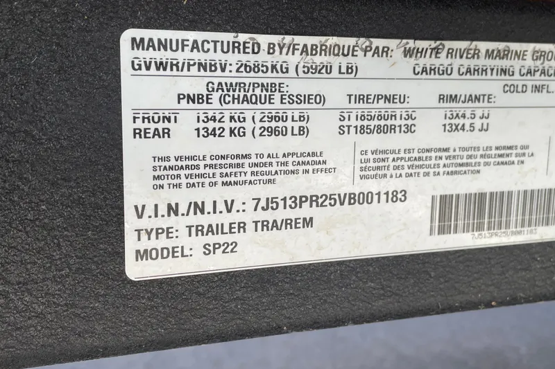 Slide: The Image of Label on Sun Tracker SportFish 22 DLX trailer, displaying specifications and VIN details. - 104