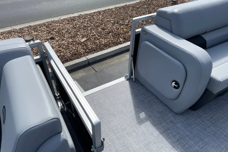 Slide: The Image of 2027 Sun Tracker SportFish 22 DLX pontoon boat interior with gray seating and flooring. - 24