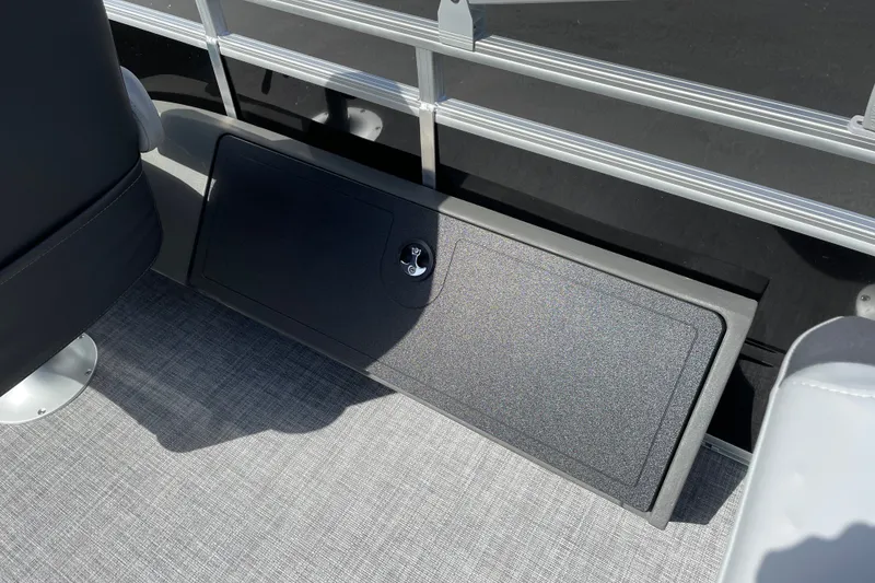 Slide: The Image of 2027 Sun Tracker SportFish 22 DLX boat interior with storage compartment and seating. - 16