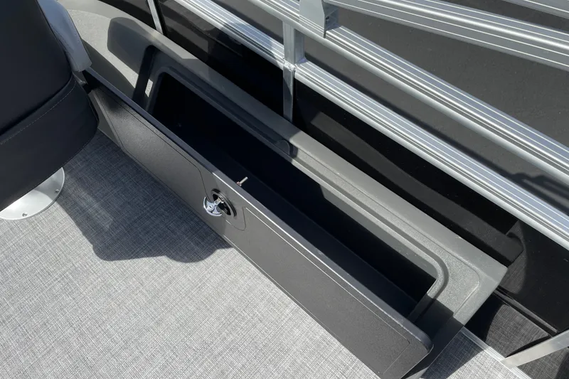 Slide: The Image of 2027 Sun Tracker SportFish 22 DLX boat storage compartment with sleek design and secure latch. - 17
