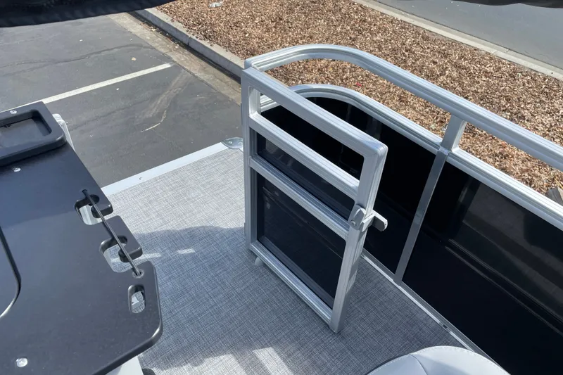 Slide: The Image of 2027 Sun Tracker SportFish 22 DLX boat deck with railing and gate. - 22