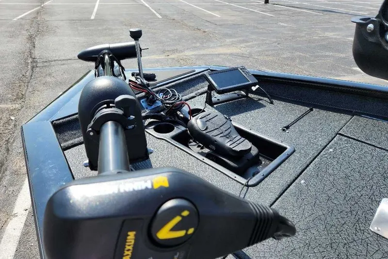 Slide: The Image of 2027 Tracker Pro Team 195 boat with advanced navigation equipment in a parking lot. - 40