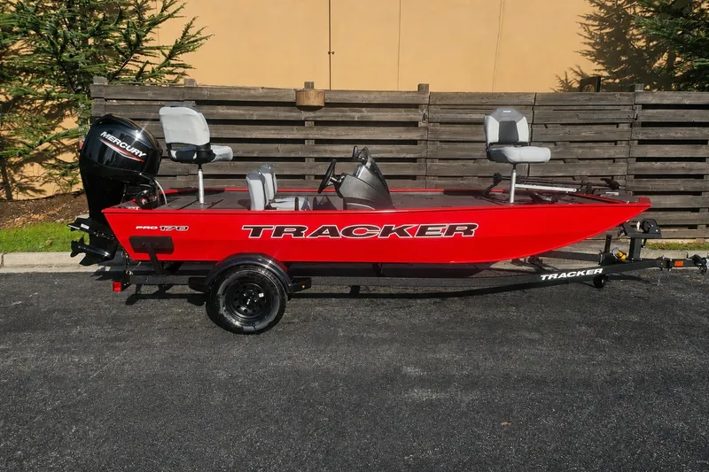 The Image of Red 2027 Tracker Pro 170 boat with Mercury engine, parked on trailer. - 0