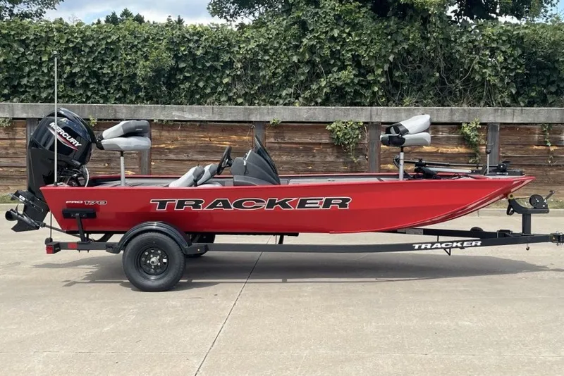 The Image of 2027 Tracker Pro 170 boat in red on trailer, parked outdoors. - 0
