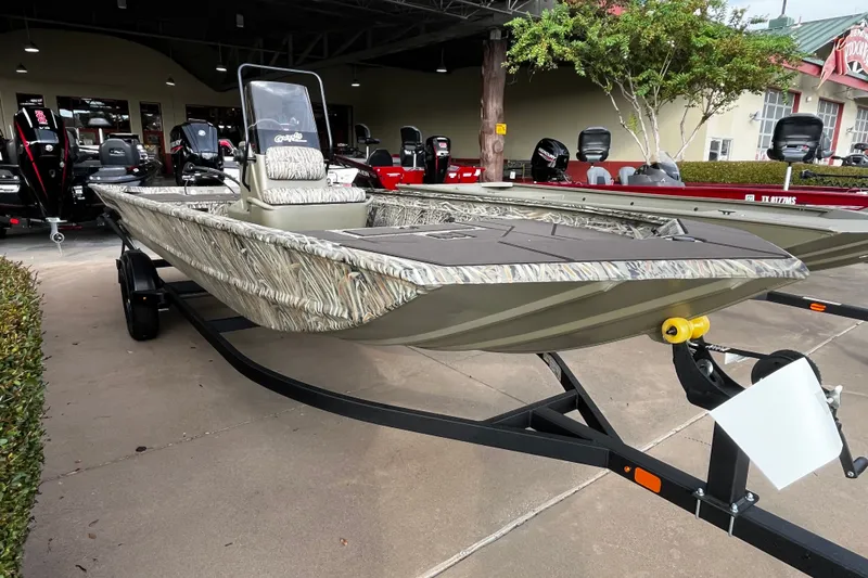 Slide: The Image of 2027 Tracker Grizzly 1860 CC boat on trailer, displayed outdoors. - 64