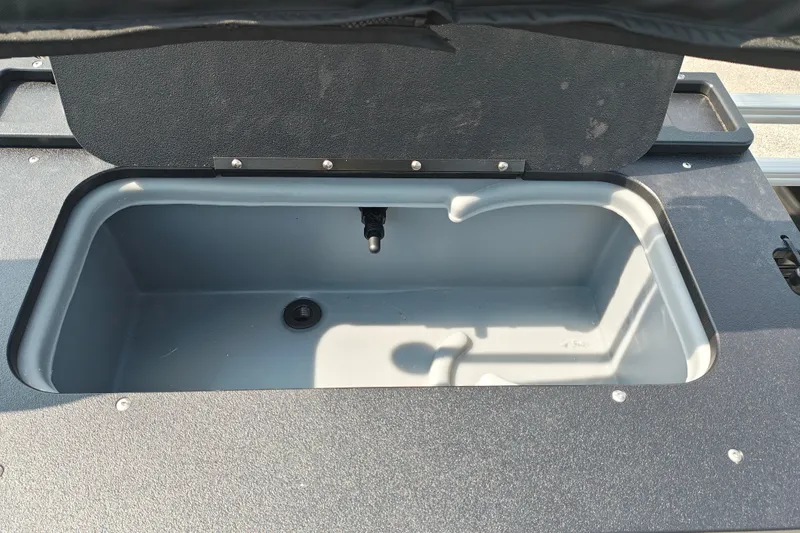 Slide: The Image of Open storage compartment on 2027 Sun Tracker SportFish 22 DLX boat. - 23
