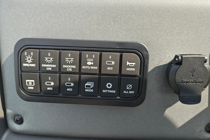 Slide: The Image of Control panel of 2027 Sun Tracker SportFish 22 DLX with various function buttons. - 16
