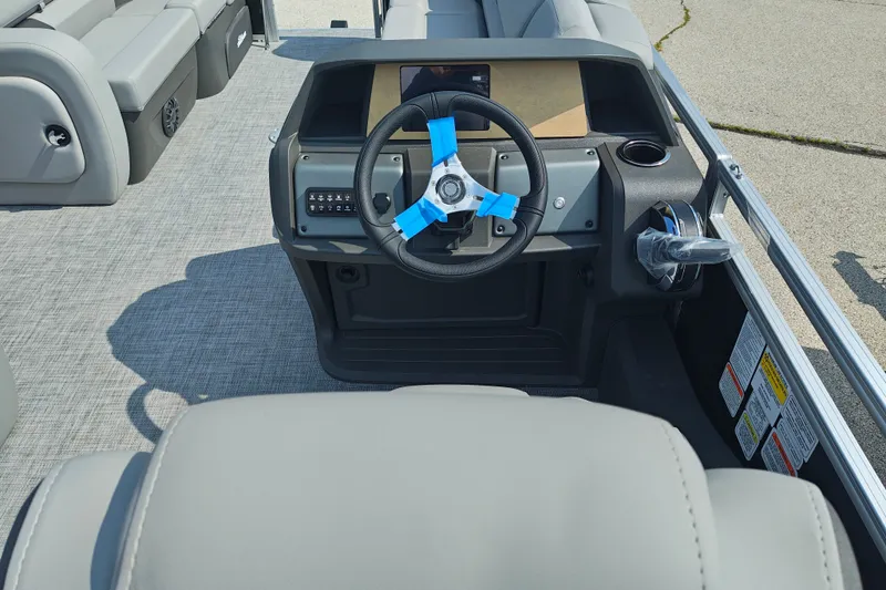 Slide: The Image of 2027 Sun Tracker SportFish 22 DLX boat interior with steering wheel and seating. - 15