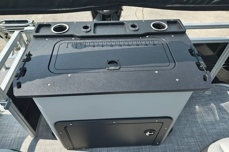 Slide: The Image of Sun Tracker SportFish 22 DLX 2027 fishing station with built-in measuring board and cup holders. - 22