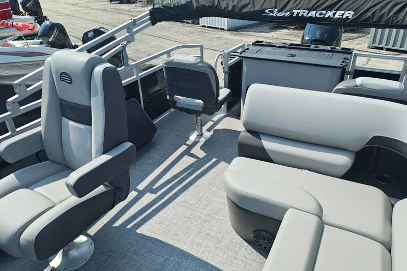 Slide: The Image of 2027 Sun Tracker SportFish 22 DLX pontoon boat interior with plush seating and helm chairs. - 13